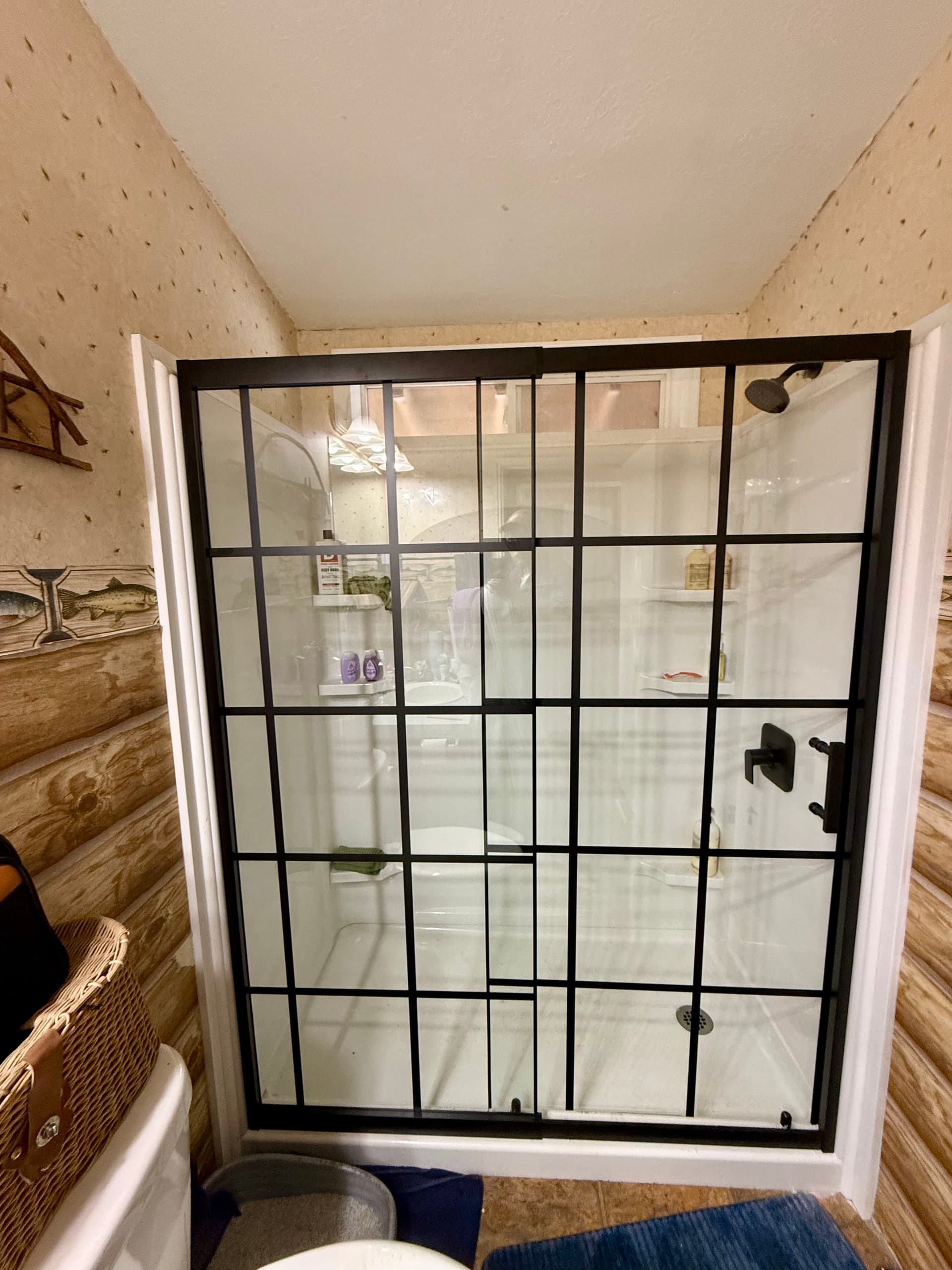 Sleek Glass Shower Door Installation in Rustic Bathroom image